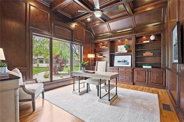 office space with plenty of natural light, a decorative wall, and visible vents