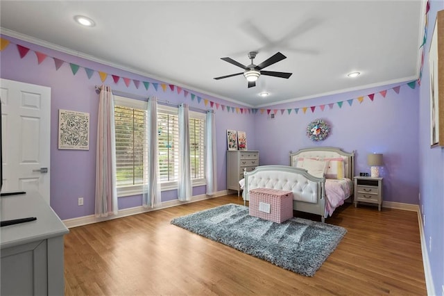 bedroom featuring baseboards, ornamental molding, and wood finished floors