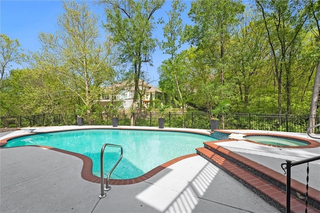 view of swimming pool with a fenced in pool, fence, an in ground hot tub, and a patio area