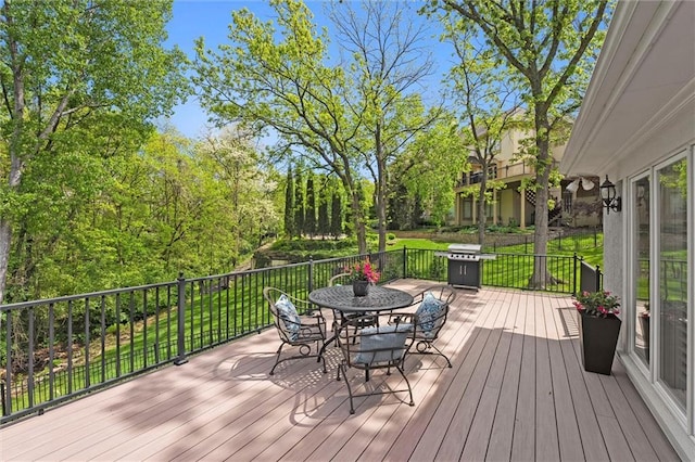 deck featuring area for grilling and outdoor dining space