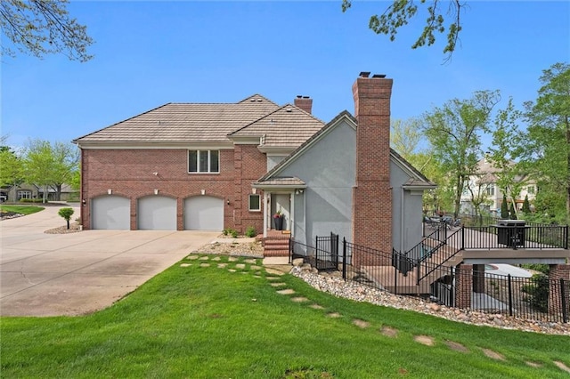 view of front of property featuring fence, a chimney, concrete driveway, and a front yard