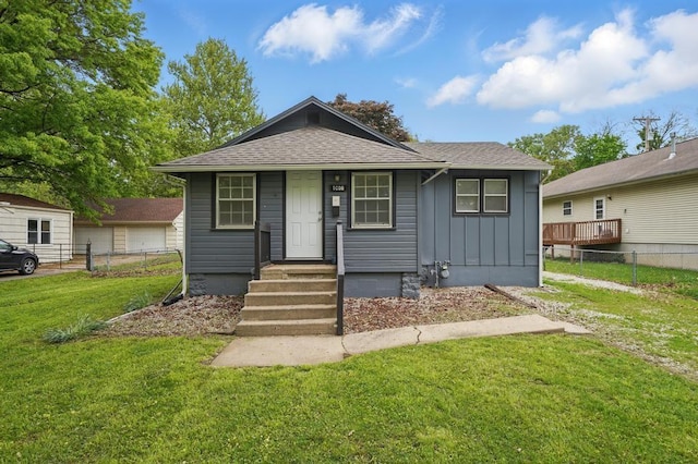 bungalow with board and batten siding and roof with shingles
