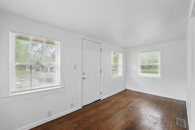 entrance foyer with dark wood finished floors and baseboards