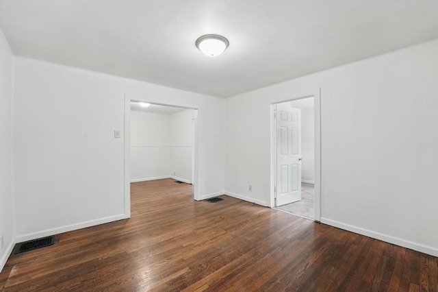 empty room with wood finished floors and baseboards