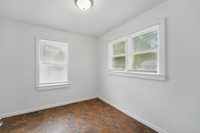 unfurnished room with baseboards
