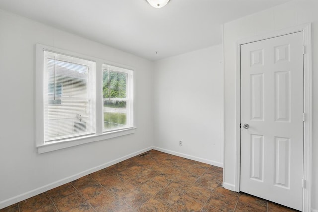 empty room with baseboards