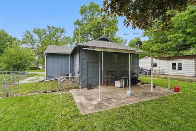 rear view of house with a patio, board and batten siding, a gate, and a shingled roof