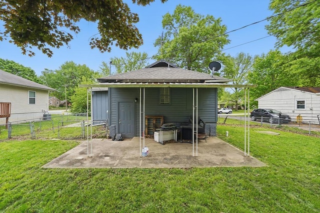 rear view of property with a patio and a shingled roof