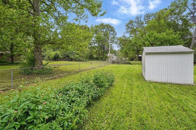 view of yard featuring a storage unit and an outbuilding
