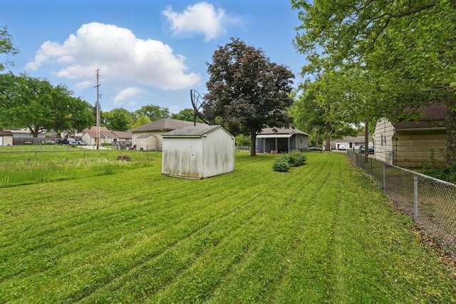 view of yard with a storage shed and an outbuilding