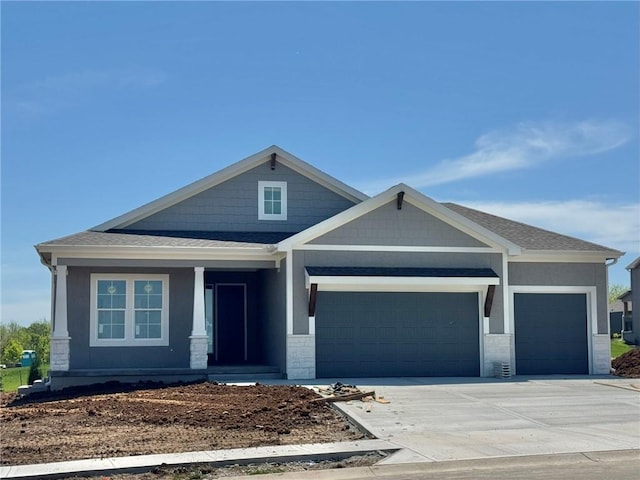 24919 W 145th St, Olathe, KS 66061 - craftsman inspired home featuring a garage, a porch, driveway, a shingled roof, and stone siding