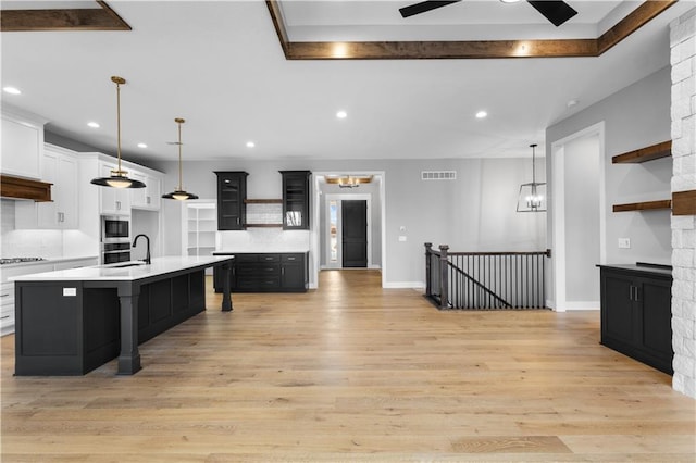 24919 W 145th St, Olathe, KS 66061 - kitchen with open shelves, light countertops, recessed lighting, light wood-style floors, and stovetop