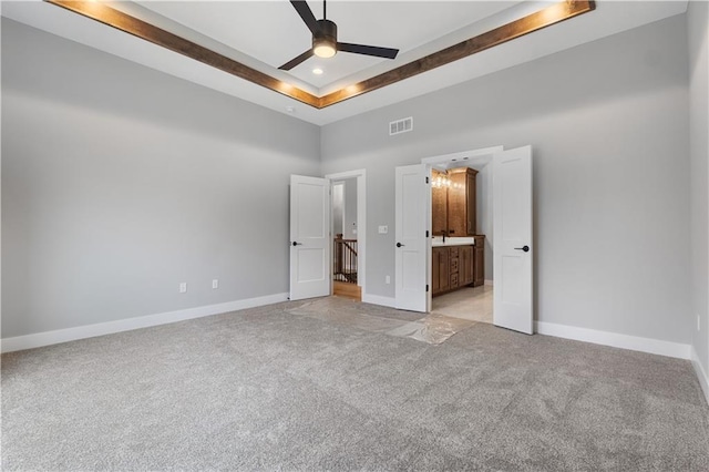 24919 W 145th St, Olathe, KS 66061 - unfurnished bedroom featuring light colored carpet, a high ceiling, baseboards, and ensuite bath