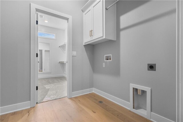 24919 W 145th St, Olathe, KS 66061 - washroom with cabinet space, washer hookup, electric dryer hookup, light wood-style flooring, and baseboards