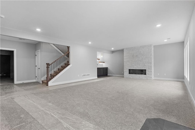 24919 W 145th St, Olathe, KS 66061 - unfurnished living room featuring carpet, stairway, recessed lighting, a fireplace, and baseboards