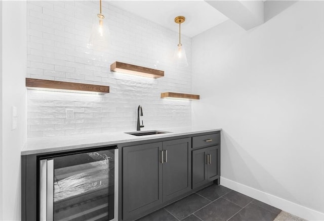 24919 W 145th St, Olathe, KS 66061 - indoor wet bar featuring beverage cooler, decorative backsplash, baseboards, hanging light fixtures, and dark tile patterned flooring