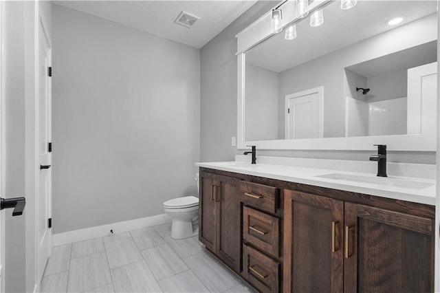 24919 W 145th St, Olathe, KS 66061 - bathroom with toilet, double vanity, baseboards, and a shower