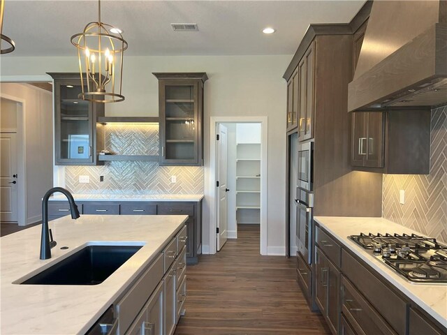 24919 W 145th St, Olathe, KS 66061 - kitchen featuring wall chimney range hood, a sink, stainless steel appliances, backsplash, and recessed lighting