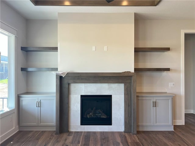 24919 W 145th St, Olathe, KS 66061 - unfurnished living room with a fireplace, dark wood-style floors, and healthy amount of natural light