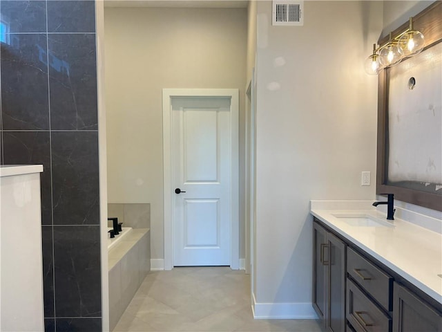 24919 W 145th St, Olathe, KS 66061 - bathroom with a garden tub, double vanity, baseboards, and tile patterned flooring