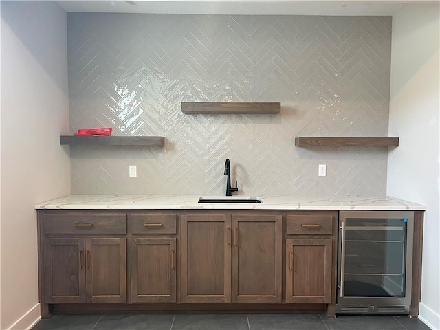 24919 W 145th St, Olathe, KS 66061 - indoor wet bar featuring wine cooler, tile patterned flooring, baseboards, and decorative backsplash