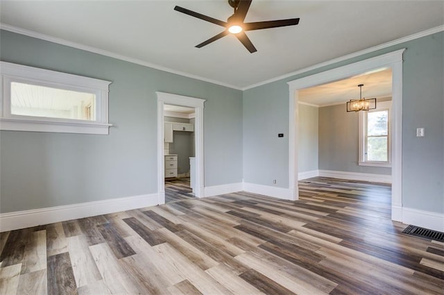 611 E 8th St, Wellsville, KS 66092 - spare room with baseboards, ceiling fan with notable chandelier, and wood finished floors