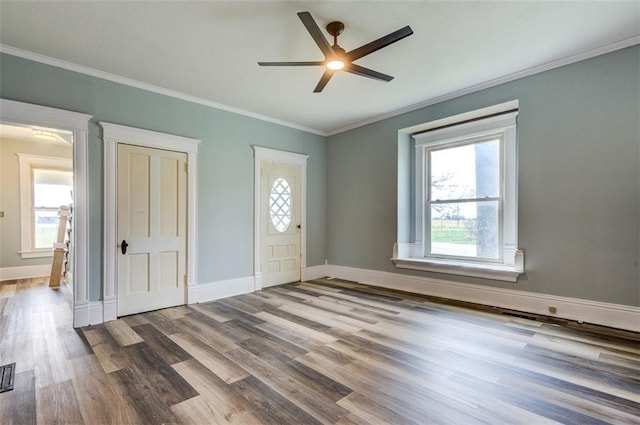 611 E 8th St, Wellsville, KS 66092 - foyer entrance featuring a healthy amount of sunlight, baseboards, a ceiling fan, and wood finished floors