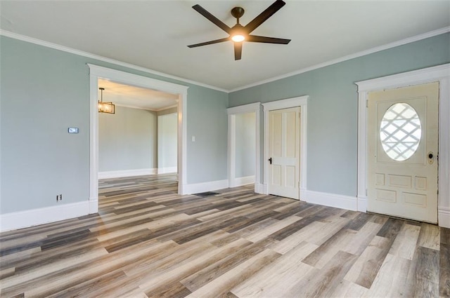611 E 8th St, Wellsville, KS 66092 - entryway featuring baseboards, ceiling fan with notable chandelier, and wood finished floors