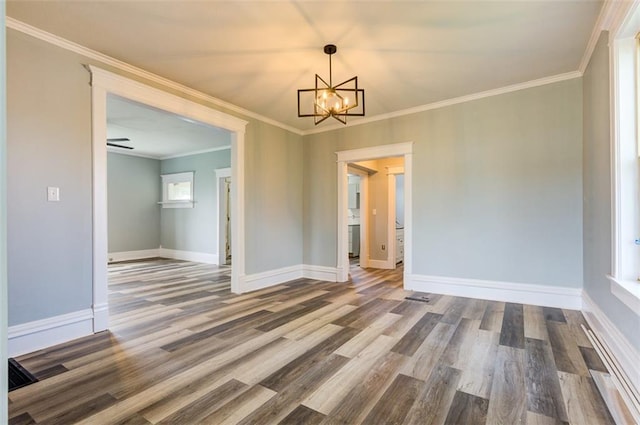 611 E 8th St, Wellsville, KS 66092 - unfurnished dining area featuring an inviting chandelier, baseboards, ornamental molding, and wood finished floors
