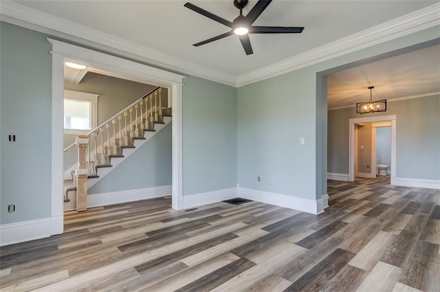 611 E 8th St, Wellsville, KS 66092 - spare room featuring baseboards, stairs, crown molding, and wood finished floors