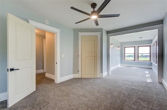 611 E 8th St, Wellsville, KS 66092 - unfurnished bedroom featuring a ceiling fan, baseboards, and carpet