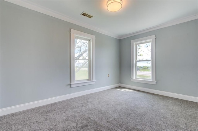 611 E 8th St, Wellsville, KS 66092 - carpeted empty room with visible vents, plenty of natural light, crown molding, and baseboards