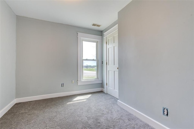 611 E 8th St, Wellsville, KS 66092 - empty room with visible vents, carpet, and baseboards