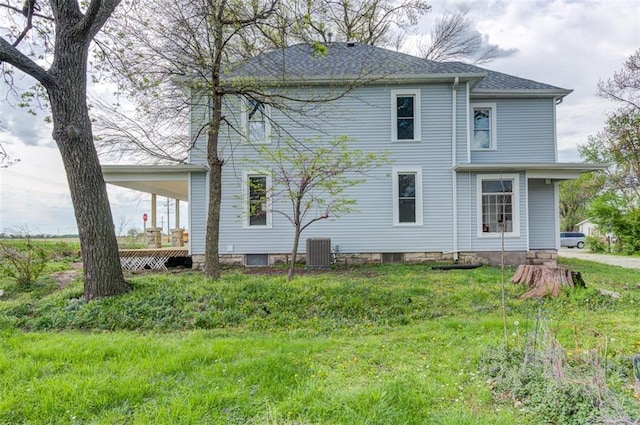 611 E 8th St, Wellsville, KS 66092 - back of house with central air condition unit and a yard