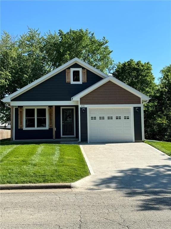 craftsman-style house with an attached garage, a front yard, and concrete driveway