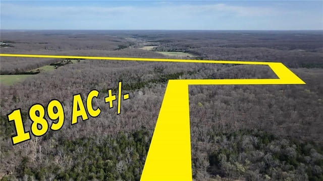 aerial overview of property's location featuring a heavily wooded area and property parcel outlined