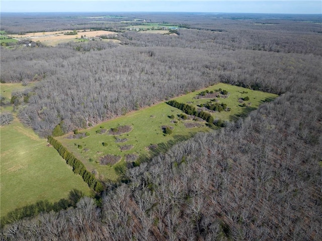 aerial view of property's location with a heavily wooded area
