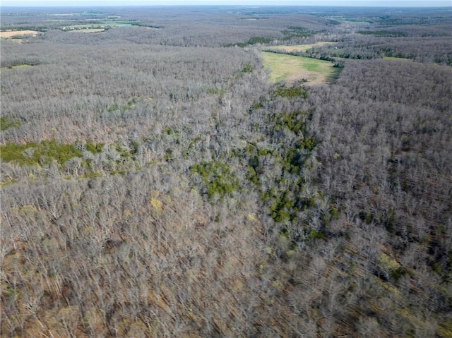 aerial view of property and surrounding area with a forest