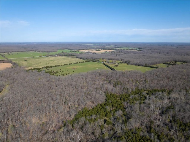 aerial view of property and surrounding area with a forest