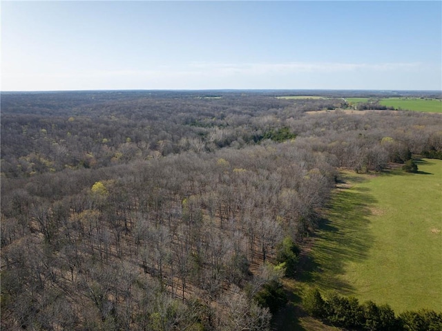 view of property location featuring a heavily wooded area