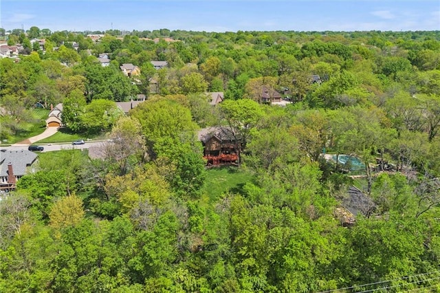 birds eye view of property featuring a view of trees