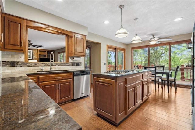 kitchen with ceiling fan, appliances with stainless steel finishes, plenty of natural light, and a sink