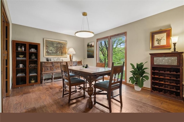 dining area with baseboards and hardwood / wood-style floors