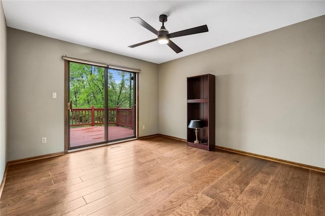 unfurnished room with baseboards, ceiling fan, and light wood finished floors