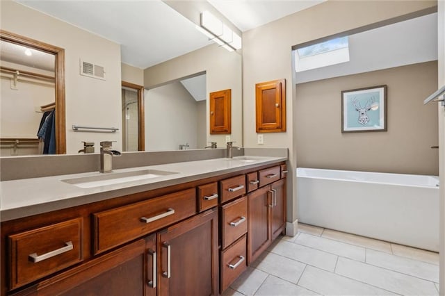 bathroom featuring double vanity, visible vents, and a sink