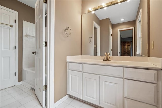 bathroom with tile patterned flooring, baseboards, shower / tub combination, and vanity
