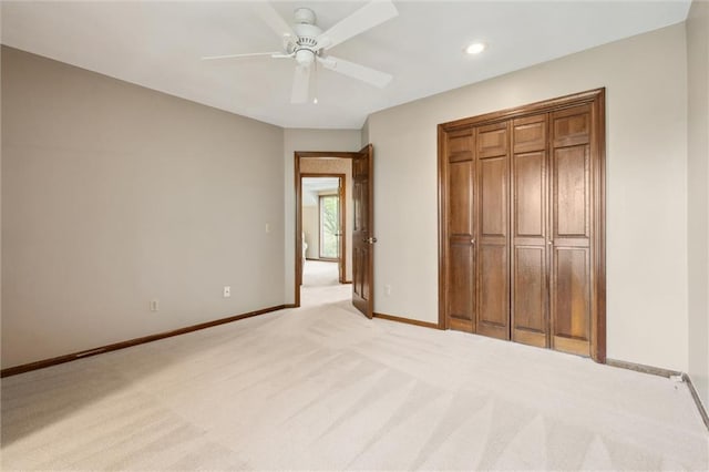 unfurnished bedroom featuring ceiling fan, light colored carpet, recessed lighting, baseboards, and a closet
