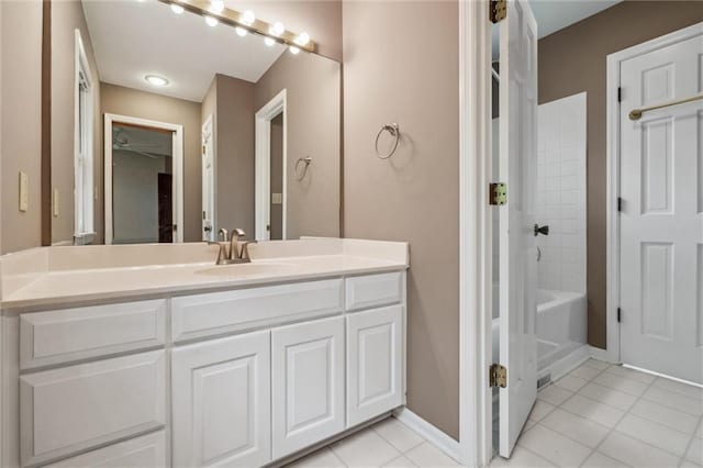 bathroom with vanity, baseboards, tile patterned floors, and shower / washtub combination