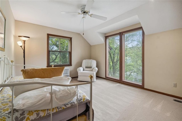 bedroom with baseboards, visible vents, light carpet, and ceiling fan