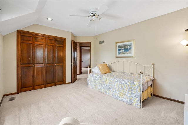 bedroom with light colored carpet, baseboards, visible vents, and a closet